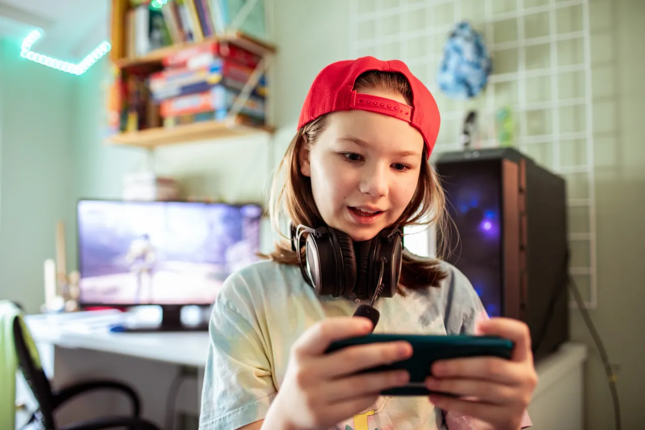 A young gamer enjoying a mobile game